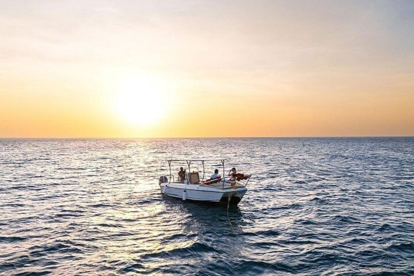 A boat on calm water during sunset. 5