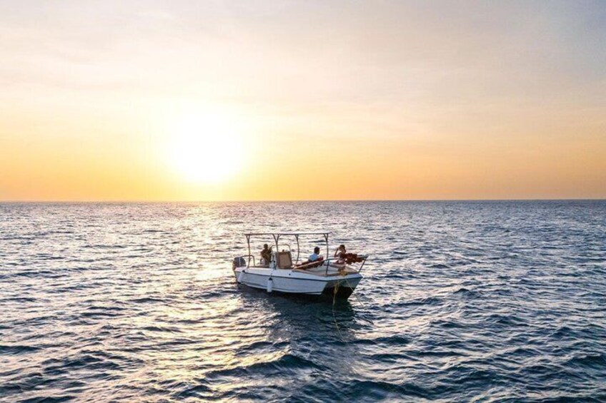 A boat on calm sea water during sunset. 5