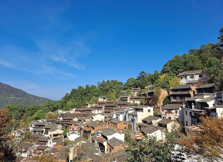 A traditional village with tiered houses nestled in a mountainous area. 3