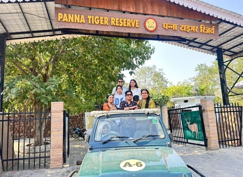 A group of people on a vehicle at Panna Tiger Reserve entrance. 1