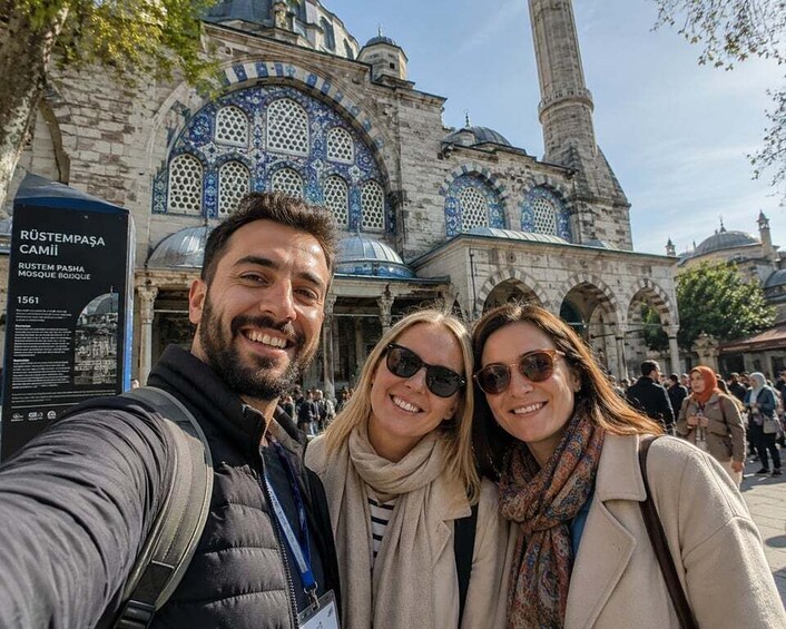 A historic building with intricate blue tile work and a tall minaret. 3