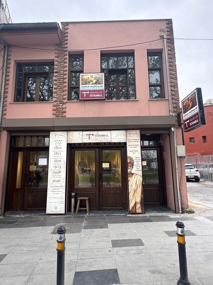 A two-story building with a sign for 'Tastes of Istanbul' and a historical timeline of the city. 2