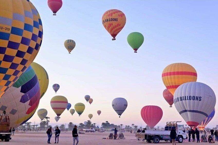 A hot air balloon festival with colorful balloons and spectators. 1