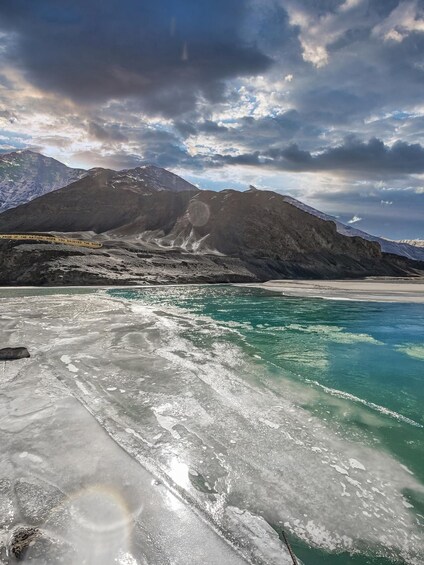 A frozen lake with mountains in the background. 1