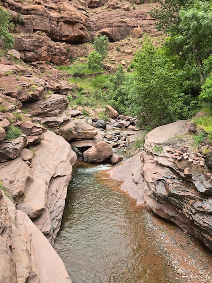 A rocky canyon with a flowing stream. 4