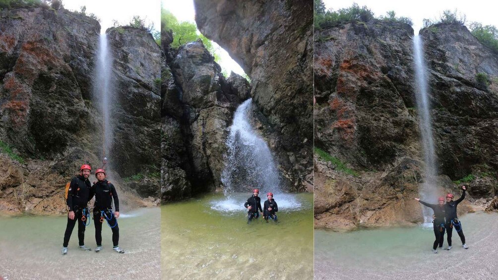 A waterfall with people standing in front of it. 2