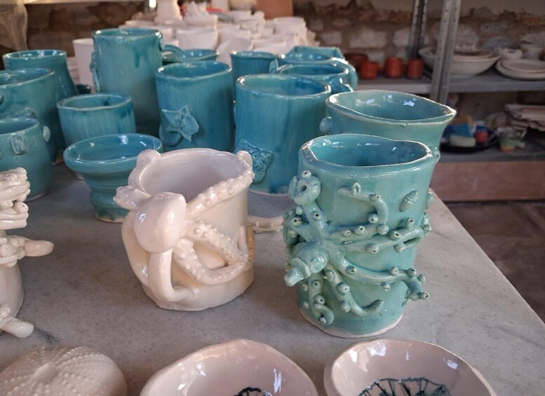 A variety of ceramic mugs and bowls on display. 4