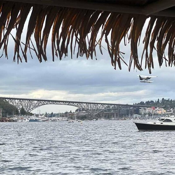 A bridge, boats, and a cityscape across a body of water. 5