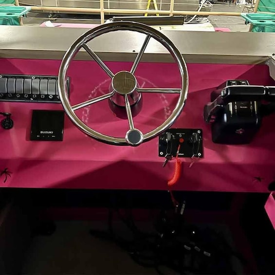 A red Suzuki vehicle with a steering wheel, dashboard, and control panel. 4