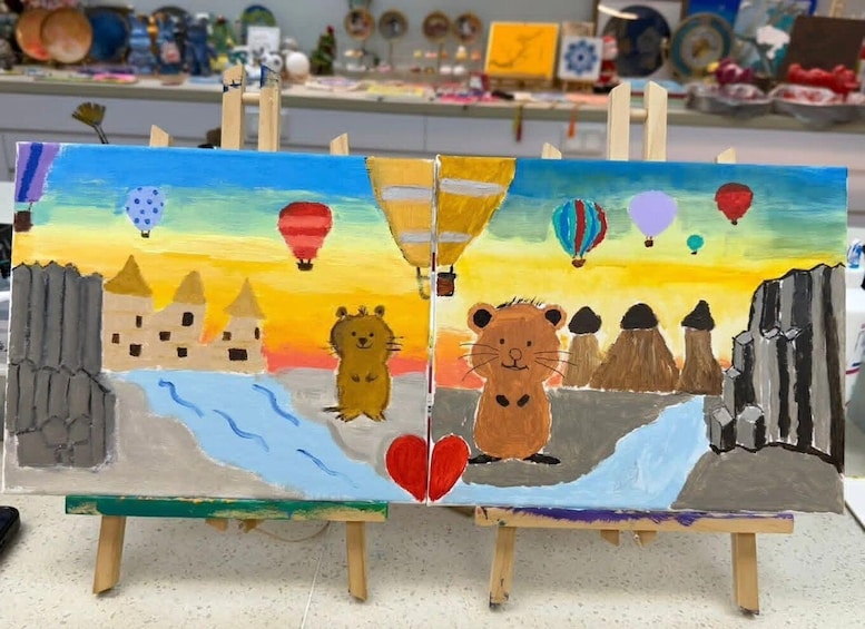 A painting of a landscape with mountains, a river, and animals, including a lion and a bear, with hot air balloons in the sky. 3