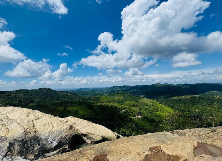 A mountainous landscape with a clear sky and scattered clouds. 1