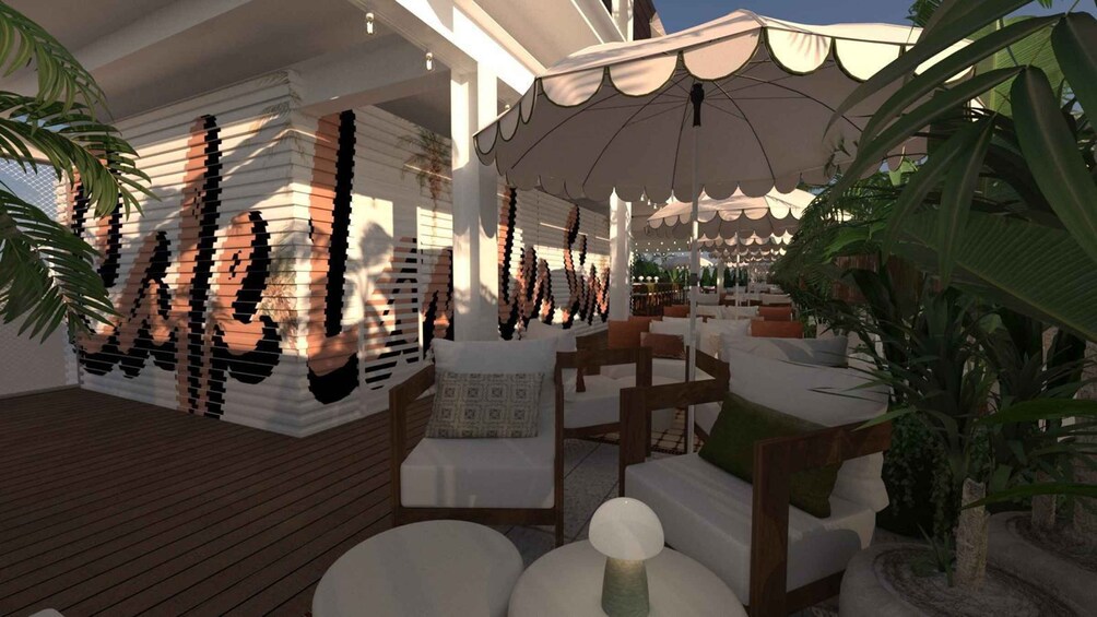 An outdoor seating area with wooden tables and chairs, surrounded by potted plants and a patterned wall. 3