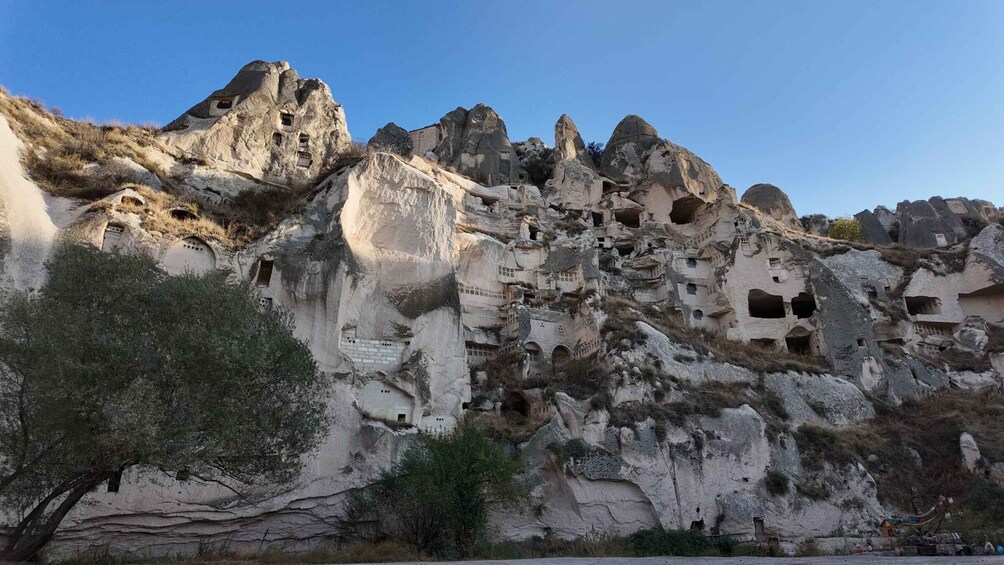 A rocky cliff with ancient rock-cut architecture. 1