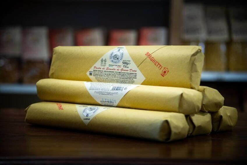 Three packages of spaghetti on a wooden surface. 5