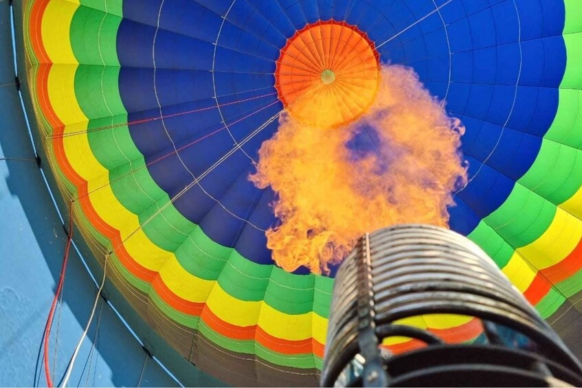 A hot air balloon with a colorful pattern and a visible burner at the bottom. 2