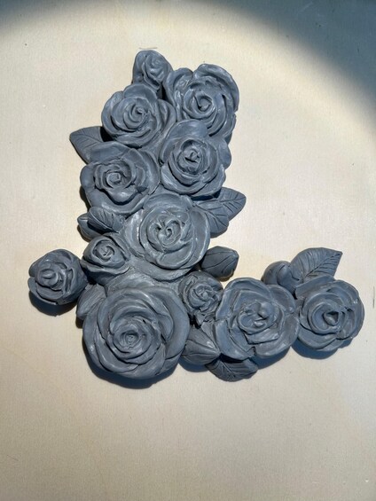A collection of gray, textured sculptures resembling roses. 5