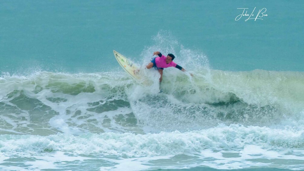 A surfer riding a wave in the ocean. 2