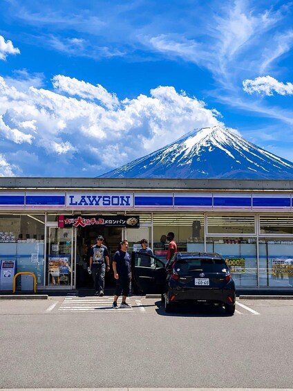 A Lawson convenience store with a view of Mount Fuji in the background. 1