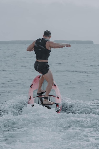 A person riding a wakeboard on a body of water. 2