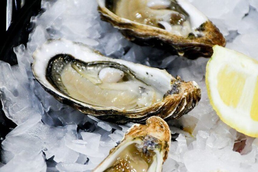 Oysters on ice with a lemon wedge. 1