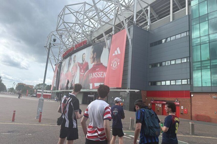 A stadium with a large advertisement for JANSEN and a red banner. 2
