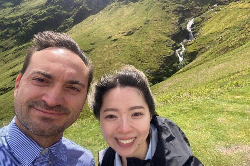 Two people in a mountainous landscape with a stream. 3