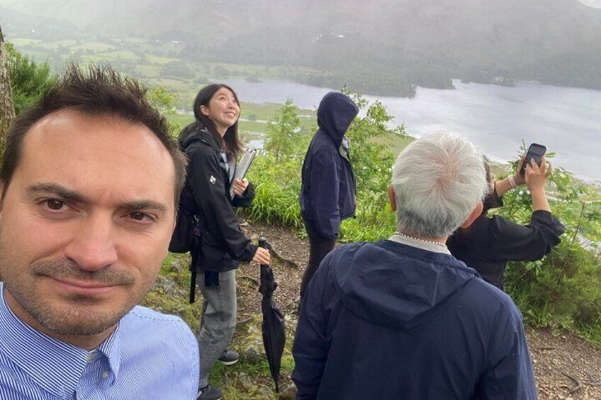 A group of people on a hillside overlooking a body of water. 5