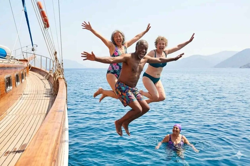 People jumping into the sea from a wooden boat. 1