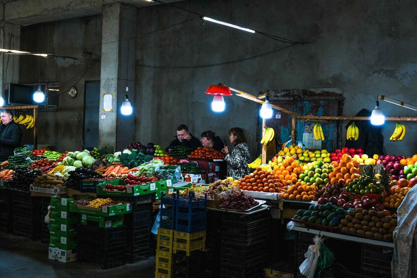A fruit and vegetable market with various produce on display. 5