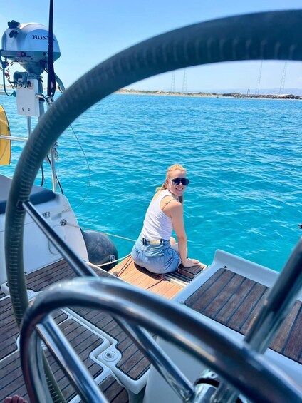 A person on a boat with a view of a bridge in the distance. 1