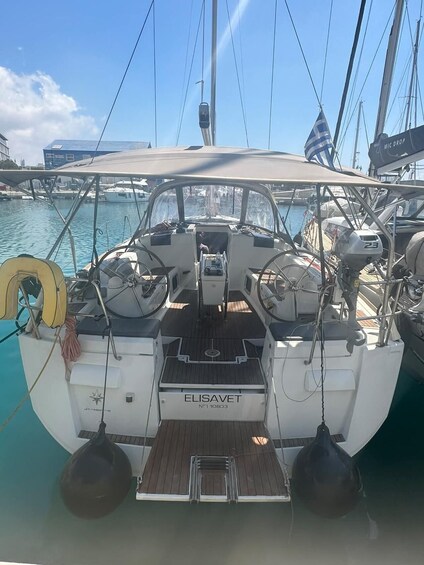 A sailboat named 'ELISAVET' docked at a marina with other boats in the background. 4
