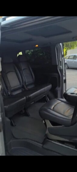 A vehicle interior with black seats and a sunroof. 4