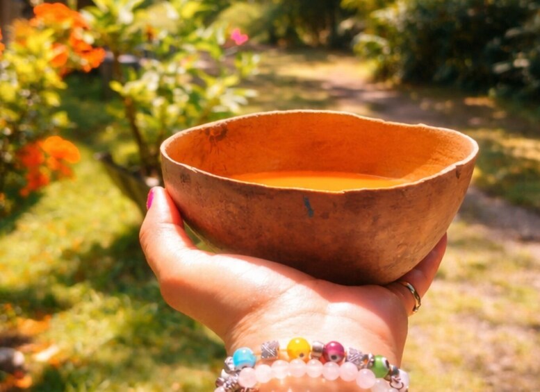 A hand holding a brown bowl. 5