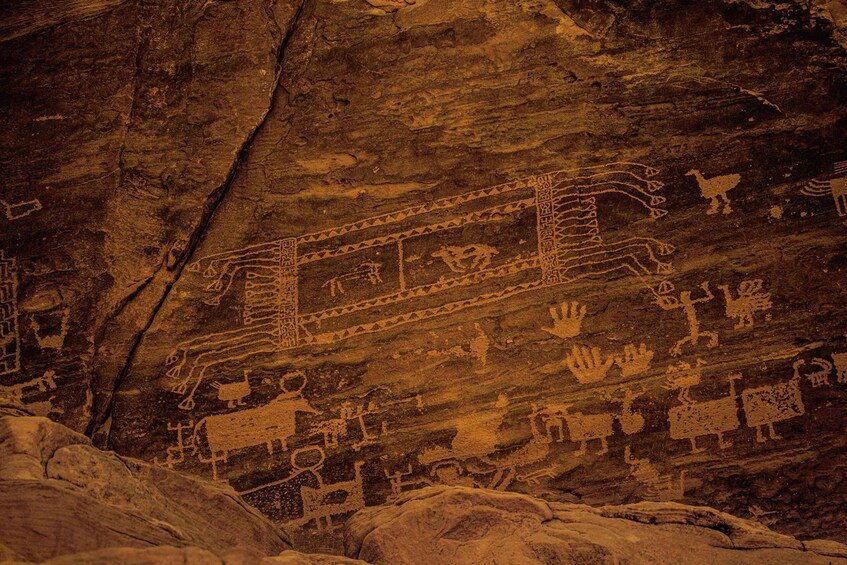 Ancient rock art with animal figures and geometric patterns. 1