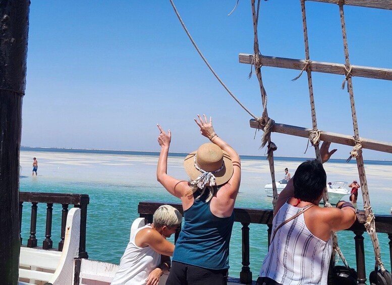 A wooden structure with ropes, overlooking a calm sea and a clear sky. 4