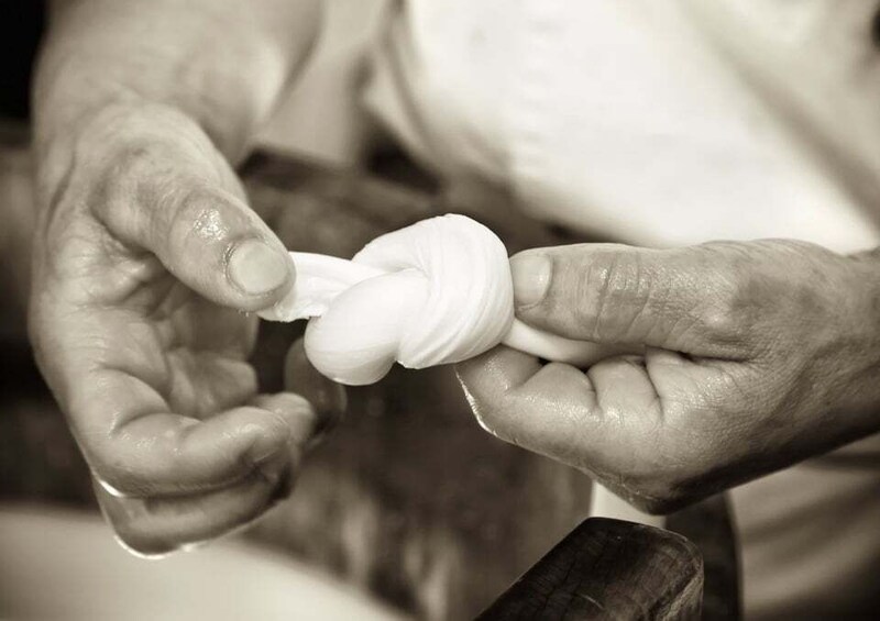 Hands shaping a white, twisted object. 1