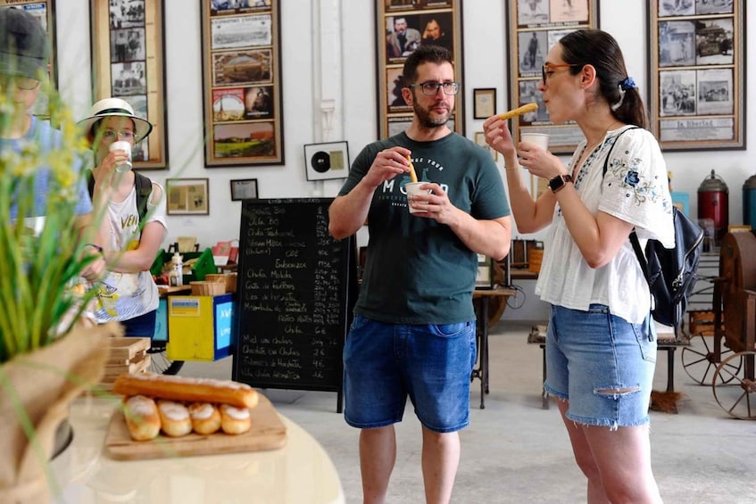 A café with a chalkboard menu, a counter with pastries, and vintage posters on the wall. 5