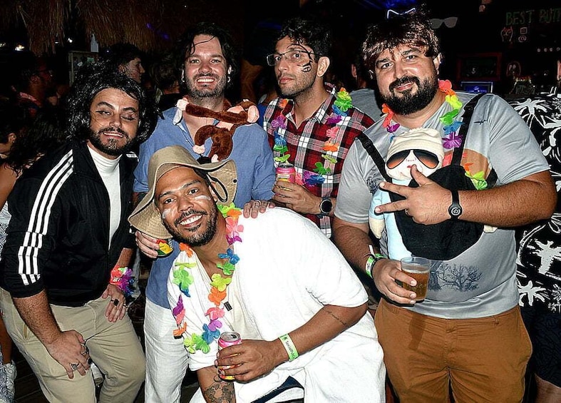 A group of people at a social event, some wearing leis. 5