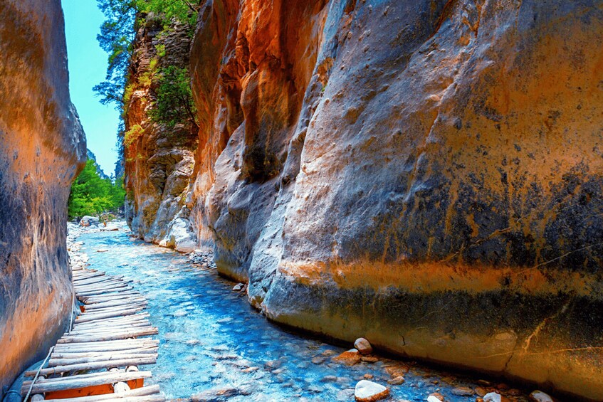 A narrow canyon with a wooden walkway. 2