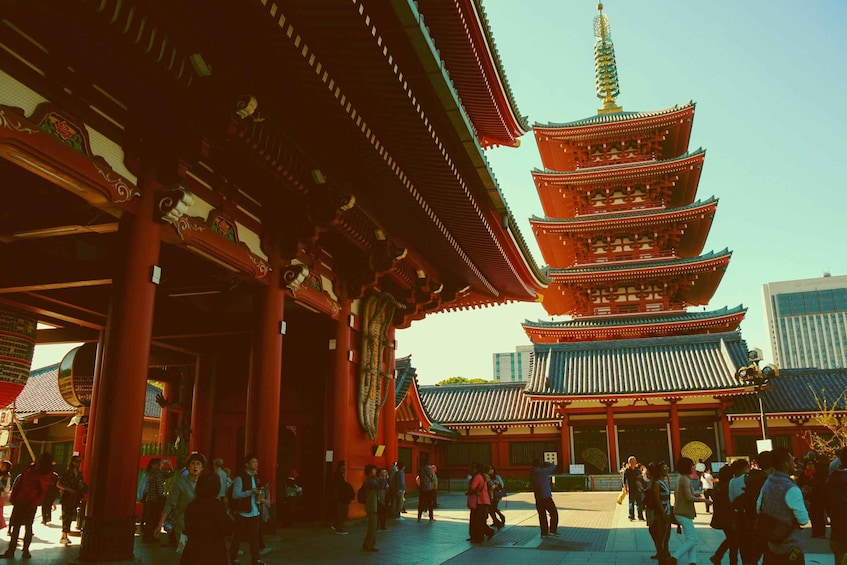 A traditional multi-tiered pagoda with red pillars and a clear blue sky. 3