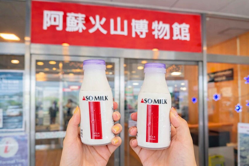 Two hands holding bottles of So Milk 200ml. 2