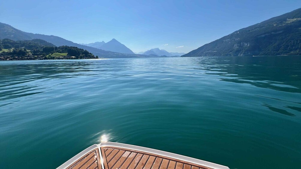 A calm lake with mountains in the background. 2