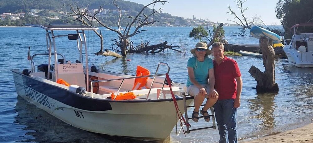 A boat named 'Boat Tours' docked at a pier with a person standing beside it. 3