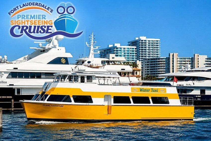 A yellow and white water taxi docked at a marina with a city skyline in the background. 1