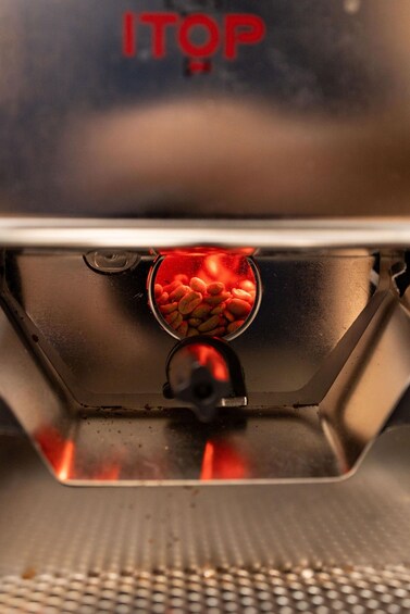 A portable grill with a visible fire burning inside, and the word 'ITOP' on the lid. 1