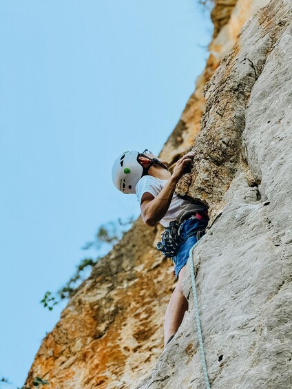 A person climbing a rock face. 3