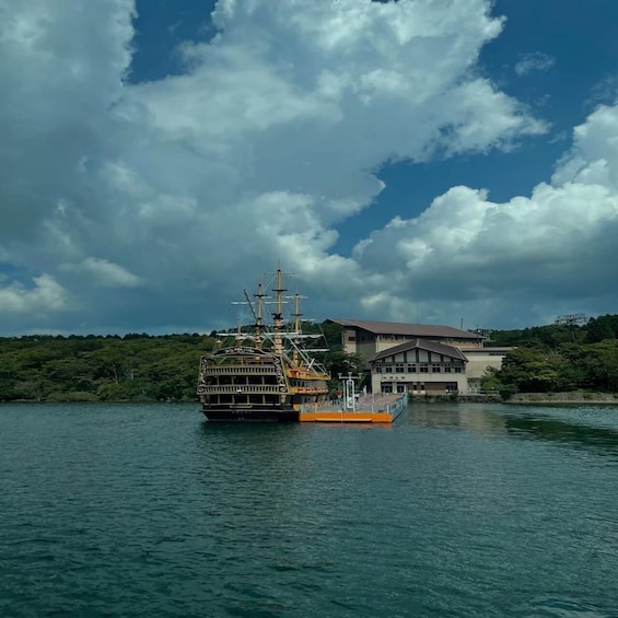 A ship docked at a pier with a building in the background. 4