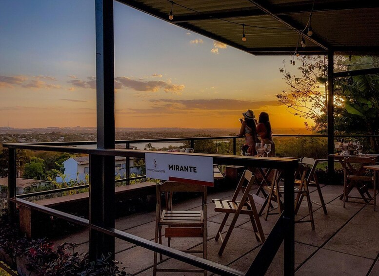 A sunset view from a terrace with a sign reading 'MIRANTE.' 1