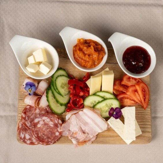 A charcuterie board with various meats, cheeses, and condiments. 2