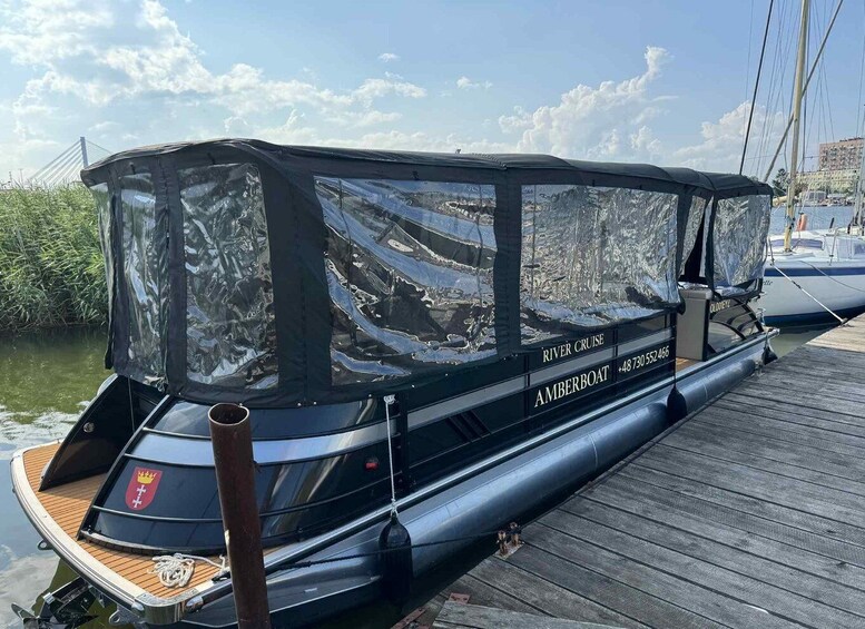 A river cruise boat named 'AMBERBOAT' docked at a pier with a wooden deck. 2